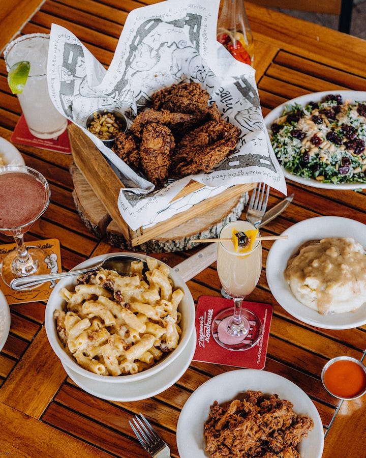 A table set with bbq chicken and mac and cheese